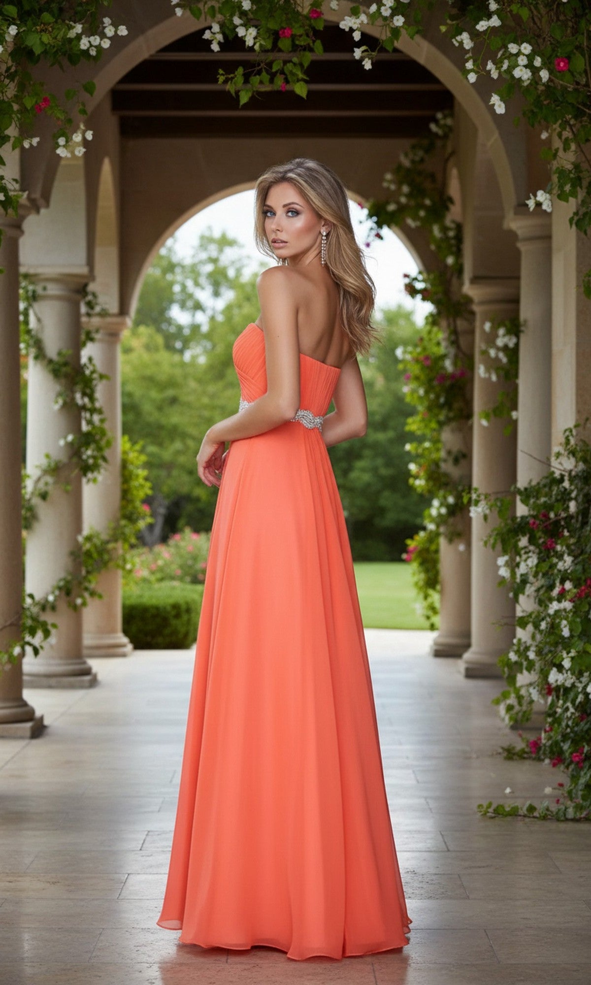A woman in the Simple Strapless Long Prom Dress, La Femme 21218, stands on a stone terrace with arches and greenery behind her, glancing over her shoulder.